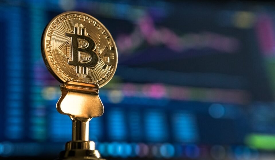 Bitcoin Price Prediction: Key Levels to Watch After August’s Rally Stalls Bitcoin coin near a rising price chart on a monitor, representing technical analysis