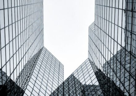 Glass corporate office building representing public companies with Bitcoin treasuries