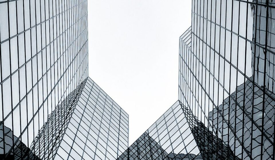 Corporate Bitcoin Treasury Strategy Explained: How Public Companies Hold BTC in 2026 Glass corporate office building representing public companies with Bitcoin treasuries